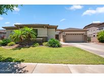 Charming single-story home featuring a well-manicured lawn, stone accents, and a spacious three-car garage at 8417 W Northview Ave, Glendale, AZ 85305
