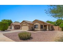 Charming single-story home features a tile roof, two-car garage, and desert landscaping at 10646 E Enid Ave, Mesa, AZ 85208