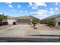 Charming single-story home featuring a well-kept front yard, desert landscaping, and an attached two-car garage at 12410 W Flores Dr, El Mirage, AZ 85335