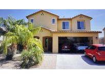 Two-story home with a three-car garage, desert landscaping, and well-maintained front yard at 1309 W Park St, Phoenix, AZ 85041