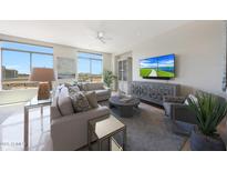 Bright living room features large windows with views and comfortable seating arrangements at 15802 N 71St St # 552, Scottsdale, AZ 85254