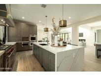 Elegant kitchen featuring custom cabinets, marble countertops, and pendant lighting at 2315 E Mine Creek Rd, Phoenix, AZ 85024