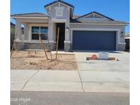 Charming single-story home with a blue garage door and a well-manicured lawn at 25466 W Graham Trl, Buckeye, AZ 85326