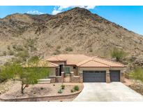 Charming home with a tile roof and stone accents, nestled against a scenic desert mountain backdrop at 2722 W Hiddenview Dr, Phoenix, AZ 85045