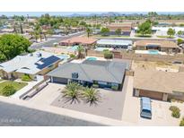An aerial view of a home showcasing mature landscaping, desert accents, and a private backyard at 310 E Fremont Dr, Tempe, AZ 85282