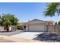 Charming single-story home with a well-manicured front yard and a two-car garage at 4116 W Marshall Ave, Phoenix, AZ 85019