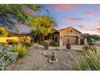 Charming desert home with a well-manicured front yard, mature trees, and a two-car garage at 8139 E Club Village Dr, Gold Canyon, AZ 85118