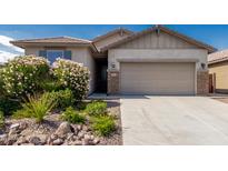 Charming single-Gathering home featuring a two-car garage and low-maintenance desert landscaping at 9822 W Caron Dr, Peoria, AZ 85345