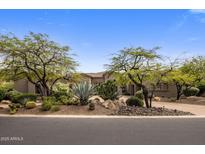 Beautiful desert landscaping with mature trees in front of this home, providing privacy and curb appeal at 10511 E Skinner Dr, Scottsdale, AZ 85262