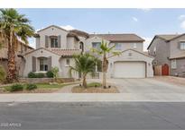 Charming two-story home boasts a well-manicured front yard, desert landscaping, and an attached two-car garage at 11142 E Ravenna Ave, Mesa, AZ 85212