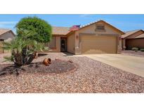 Charming single-story home featuring a well-maintained rock yard and a two-car garage at 20739 N 106Th Ave, Peoria, AZ 85382