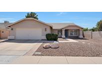 Charming single-story home showcasing a low maintenance desert-style front yard and a two-car garage at 23638 N 41St Ave, Glendale, AZ 85310