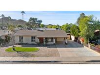 Charming single-story home with well-maintained landscaping and desert features at 2525 E Nisbet Rd, Phoenix, AZ 85032