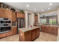 Modern kitchen features stainless steel appliances, granite countertops, and ample cabinet space at 2554 E Honeysuckle Pl, Chandler, AZ 85286