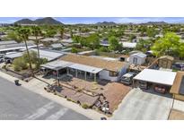 An aerial view of a well-maintained home with two carports and desert landscaping at 2956 E Sequoia Dr, Phoenix, AZ 85050