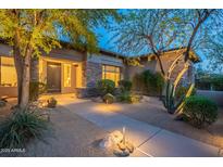 Inviting front yard featuring desert landscaping and a charming walkway leading to the home's entrance at 6069 E Ironwood Dr, Scottsdale, AZ 85266