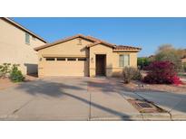 Charming single-story home with a low-maintenance landscaped front yard and attached two-car garage at 6820 S 68Th Ln, Laveen, AZ 85339