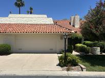 Charming home featuring a tile roof, two-car garage, and neatly landscaped front yard at 7114 E Buena Terra Way, Paradise Valley, AZ 85253
