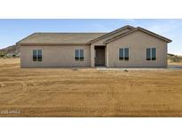 Charming single-story home featuring a neutral stucco exterior and a well-manicured front yard at 8284 W Mccartney Rd, Casa Grande, AZ 85194