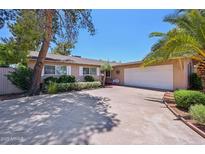 Charming single story home with a two car garage and shade trees in the front yard at 8637 E Solano Dr, Scottsdale, AZ 85250