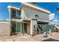 Charming two-story home with desert landscaping, green trim and neutral stucco exterior at 9050 N 51St Ln, Glendale, AZ 85302