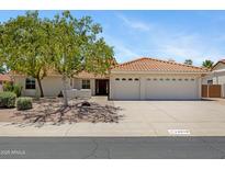 Charming single-story home with a tile roof, three-car garage, and mature landscaping at 13010 S 42Nd St, Phoenix, AZ 85044