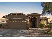 Charming single-story home with well-manicured landscaping and a two-car garage at 13153 W Cottontail Ln, Peoria, AZ 85383