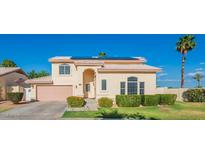 Charming single-Gathering home featuring a well-manicured lawn, desert landscaping and solar panels at 15211 N 89Th Ave, Peoria, AZ 85381