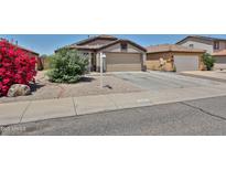 Charming single-story home with a two-car garage and low-maintenance desert landscaping at 16242 W Caribbean Ln, Surprise, AZ 85379