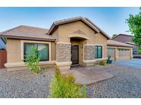 Charming single-story home with stone accents, desert landscaping and a welcoming entrance at 1849 S 96Th St, Mesa, AZ 85209