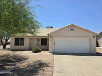 Charming single-story home featuring a well-manicured front yard and a two-car garage at 1918 S Ocotillo Dr, Apache Junction, AZ 85120