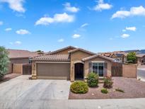 Charming single-story home with a two-car garage, desert landscaping, and a tiled roof at 2264 W Arroyo Way, San Tan Valley, AZ 85144