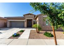 Charming single-story home featuring a well-manicured front yard, a two-car garage, and a welcoming entryway at 22944 E Via Del Oro --, Queen Creek, AZ 85142