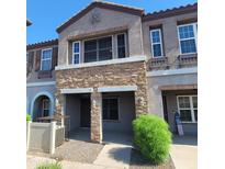 Charming two-story townhome with stone accents and well-maintained landscaping in a desirable neighborhood at 2323 E Huntington Dr, Phoenix, AZ 85040