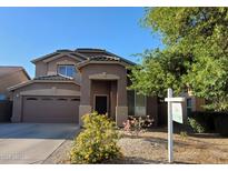 Charming two-story home featuring a well-maintained front yard and attached two-car garage at 2934 W Peggy Dr, San Tan Valley, AZ 85144