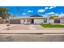 Charming single-story home with a manicured lawn and desert-friendly landscaping at 3008 S Saguaro Cir, Mesa, AZ 85202