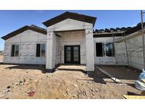 Exterior construction of home with a modern entrance featuring dark double doors at 37459 W Missouri Ave, Tonopah, AZ 85354