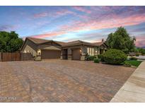 Charming single-story home with a three-car garage and a beautiful brick driveway at 4318 N 180Th Dr, Goodyear, AZ 85395