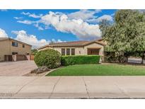 Charming single-story home with well-manicured lawn and beautiful landscaping at 4318 N 180Th Dr, Goodyear, AZ 85395