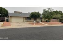 Charming single-story home featuring a well-maintained lawn and a spacious two-car garage at 4329 W Bloomfield Rd, Glendale, AZ 85304
