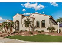 Charming stucco home featuring landscaped yard, arched entryway, and a red tile roof under a sunny blue sky at 4453 S Huachuca Way, Chandler, AZ 85249