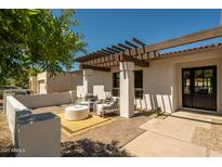 Charming outdoor patio with pergola, brick pavers, and comfortable seating for enjoying the backyard views at 7618 N Via Del Paraiso --, Scottsdale, AZ 85258