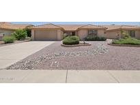 Well maintained single-story home featuring desert landscaping, a two-car garage, and a tile roof at 9263 W Oraibi Dr, Peoria, AZ 85382