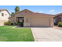 Charming single-story home with a well-manicured lawn and a two-car garage at 1029 E Jasper Dr, Gilbert, AZ 85296