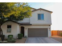 Charming two-story home featuring a two-car garage and well-manicured front yard at 1100 S 176Th Ave, Goodyear, AZ 85338
