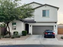Charming two-story home boasts a well-manicured front yard and an attached two-car garage at 1100 S 176Th Ave, Goodyear, AZ 85338