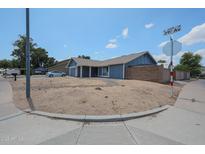 Charming single-Gathering home with blue exterior, well-maintained landscaping, and attached two-car garage at 14412 N 39Th Ave, Phoenix, AZ 85053