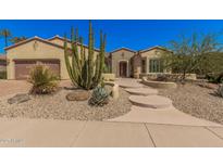 Charming single-story home featuring desert landscaping and a welcoming walkway to the front door at 16704 W Oracle Rim Dr, Surprise, AZ 85387