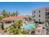 Resort-style community pool featuring lush landscaping and lounge area, perfect for relaxation at 16715 E El Lago Blvd # 212, Fountain Hills, AZ 85268