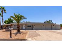 Charming single-story home featuring a three-car garage and desert landscaping, including lovely palm trees at 350 N 88Th St, Mesa, AZ 85207
